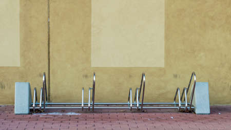 Metal bike rack by the tiled wall