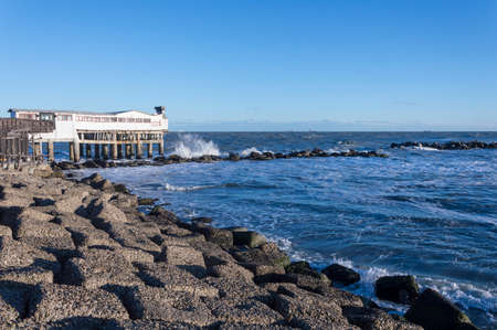 Rough sea with white house in Adriatic sea, Italy