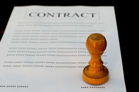 Stamp on a filled contract in a black background