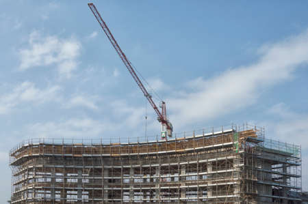 Construction site with crane on sky background