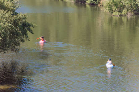The kayakers rowing in the Amazonia River