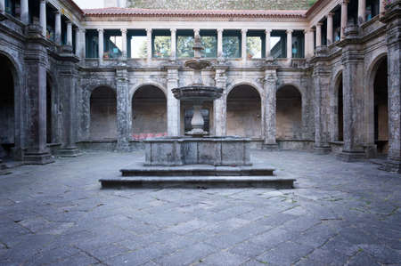 Square with fountain in an old medieval indoor garden dark atmosphereの写真素材