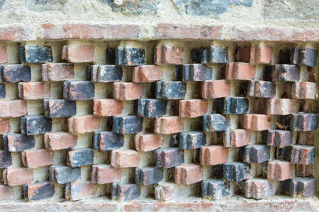 Ornamental pattern on an old brick wall