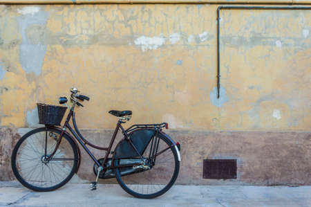 Retro bicycle with basket in front of the old wall, backgroundの写真素材