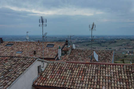 Lot of different types of antennas on roof of buildingsの写真素材