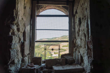 Tower prison cage, chain fence broken, possible escapeの写真素材