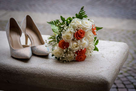 Wedding accessories for the morning of the bride in white. Wedding bouquet and shoes.の写真素材