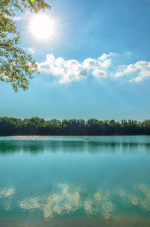 Forli, Italy, blue water lake with canoe in a sunny dayの写真素材