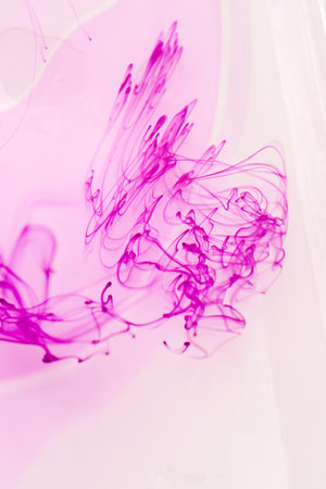 abstract background with pink ink in water, closeup of photoの写真素材