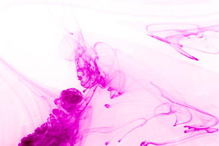 abstract pink ink in water on a white background close-upの写真素材