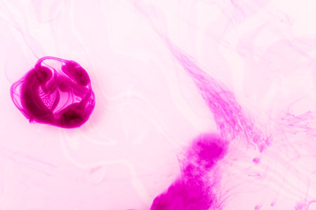 abstract background of pink ink in water close-up macro photographyの写真素材