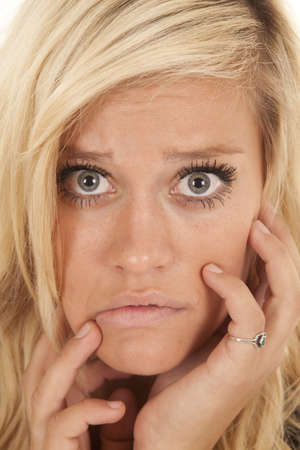 a close up of a woman's face with a scared or nervous expression on her face.の写真素材