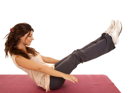 A woman exercising and doing a crunch to work her abs.の写真素材