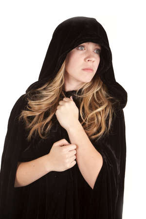 a girl with  a black cloak on with a sad expression on her face.の写真素材