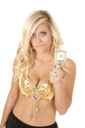 Woman holding on to her last dollar with asad expression on her face.の写真素材