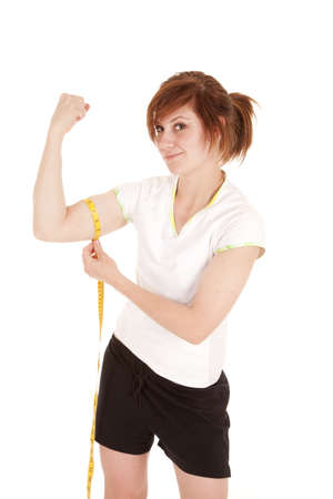 a woman measuring the size of her bicept.の写真素材