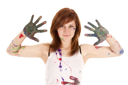 A woman showing off her messy hands and face from paint.の写真素材