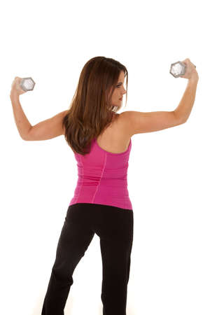 A woman's back to the camera lifting weights.の写真素材