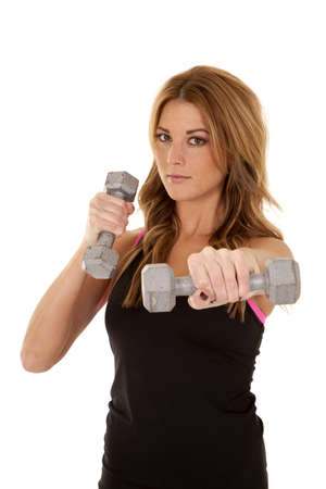 A woman holding out her weight to the camera with a serious expression on her face.の写真素材