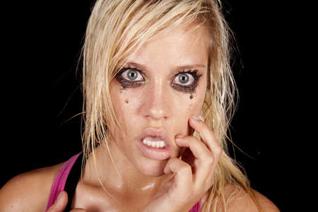 A close up of a woman that is crying and looks very unhappy and sad.の写真素材