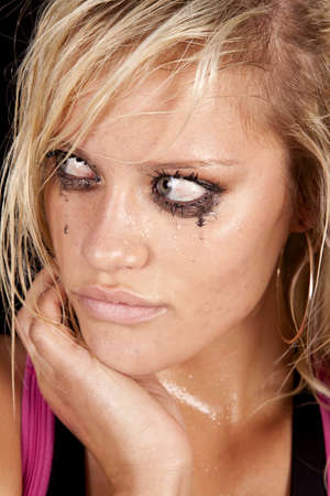 A close up of a woman that is crying and looks very unhappy and sad.の写真素材