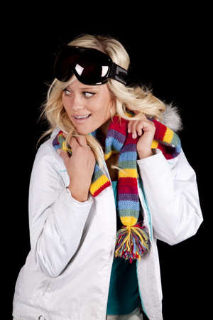 A woman is wearing a white coat with a scarf and goggles.の写真素材
