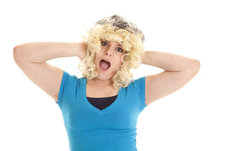 a teen girl with a wig and hat on with a funny expression on her face.の写真素材