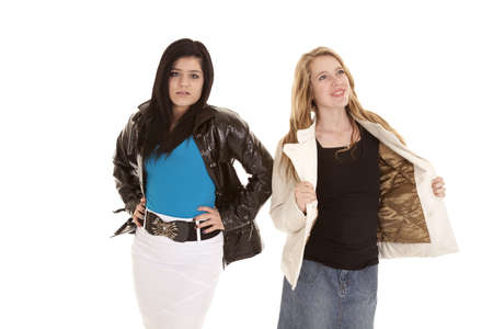 Two teens in their jackets one is happy holding open her jacket the other is not so happy.の写真素材