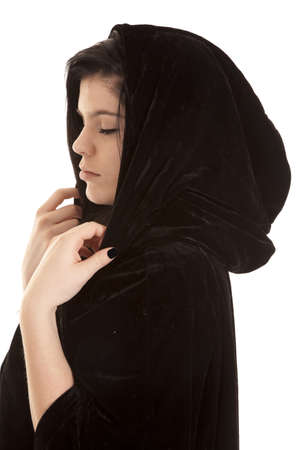 a teen wearing a black cloak with her eyes closed.の写真素材