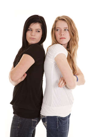 Two teen friends not happy with each other showing each other their dirty looksの写真素材