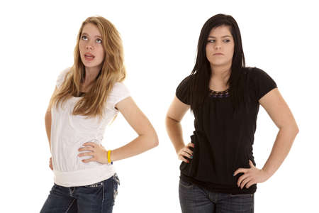 Two teen girls not happy with each other.  They are showing their serious mean sides.の写真素材