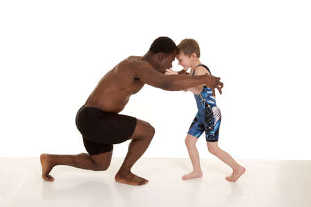 A child and a man getting ready to wrestle.の写真素材
