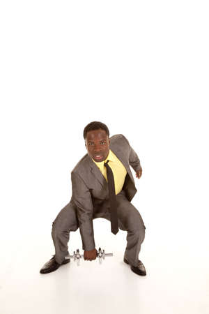 A business man trying to fit in  working out his physical body with weights.の写真素材