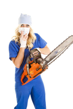 A nurse is holding a chain saw and she has blood on her.の写真素材