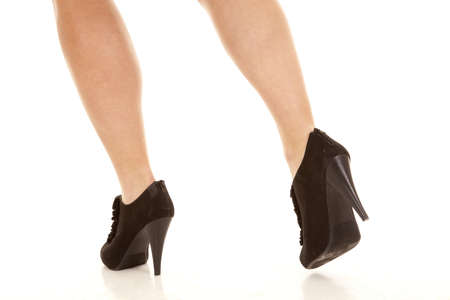 A woman walking away in her black heeled shoes.の写真素材