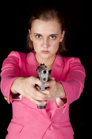 A woman is holding a gun and pointing it.