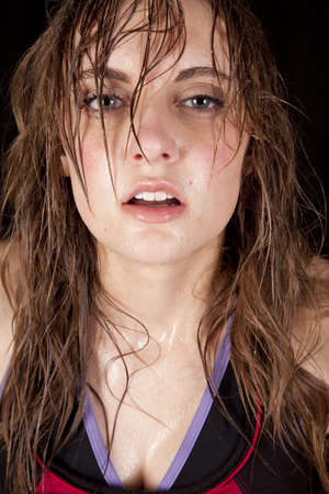 A woman with sweat running down her face after a workout.の写真素材