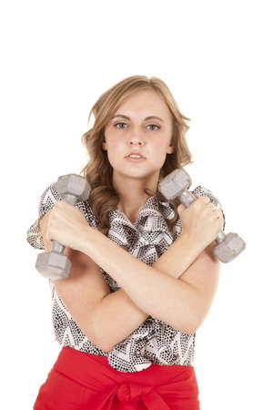 A woman is in a dress and holding some free weights.の写真素材
