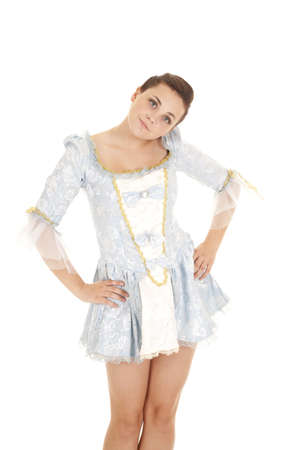 a woman in her blue dress with her hands on her hips and a serious expression on her faceの写真素材