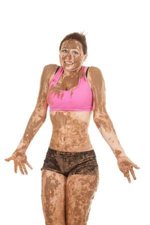 A woman covered in mud with a funny expression on her lips.の写真素材