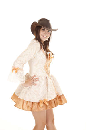 A woman standing in her orange short dress with her hat on her head.の写真素材