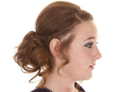A side view of a teen girl with her hair done fancy.