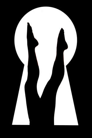A woman has her legs up and can be seen through the keyhole.の写真素材