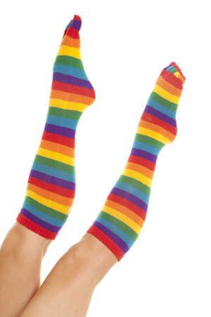A woman has socks on with toes in them and lots of striped colors.の写真素材
