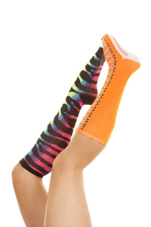 A woman has socks that don't match on holding them in the air.の写真素材