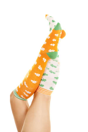 A woman with socks in the air.  They have luck clovers on them.の写真素材