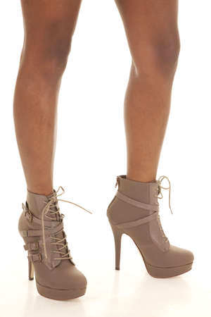 a woman standing with her brown boots on.の写真素材
