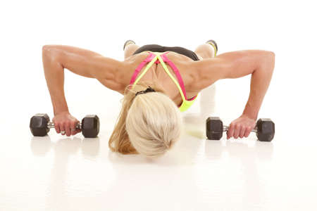 A woman is doing pushups and she is very toned.