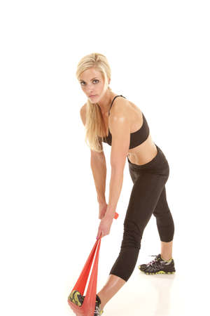 a woman stretching out her calf with a band.の写真素材