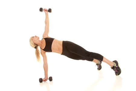 a woman lifting her weight up in the air.の写真素材